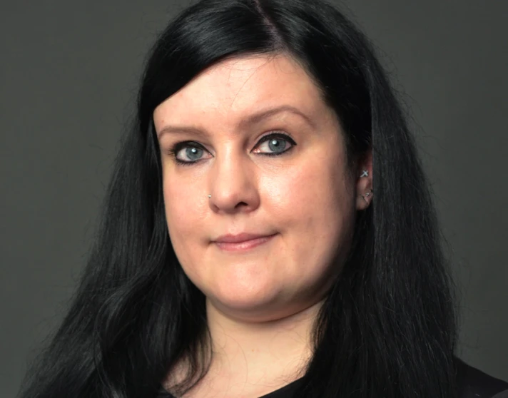 Portrait of Leah Moorhouse, lecturer at Glasgow Kelvin College, with long dark hair, wearing a black top against a plain dark background. Portrait of Leah Moorhouse, lecturer at Glasgow Kelvin College, with long dark hair, wearing a black top against a plain dark background.
